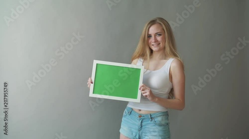 Attractive Woman shows greenkey copyspace with tracking points. photo