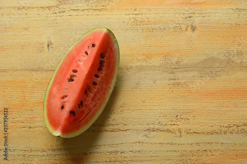 slice of watermelon isolated on wooden table