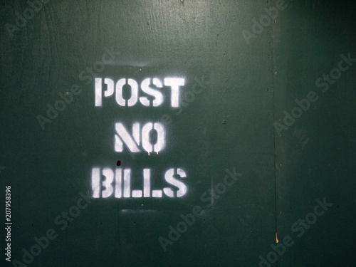 Post no bills spray painted warning sign at a city construction area
