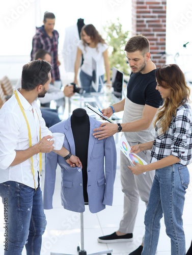 group of designers discuss men's suit