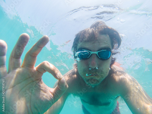 Underwater view of a man swimming in the sea
