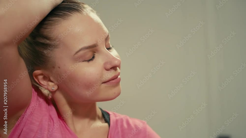 Young Tired but Satisfied Lady is Wiping Sweat after Hard Workout in Fitness Gym Young Tired but Satisfied Lady is Wiping Sweat after Hard Workout in Fitness Gym