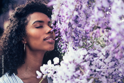 young black woman surrounded by flowers