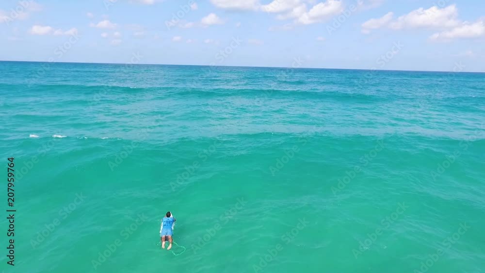 Drone shot of Surfers catching waves, Aerial view of lots of Surfers On Summer Vacation Riding Perfect Breaking Waves. Drone shot of Surfers catching waves, Aerial view of lots of Surfers On Summer Vacation Riding Perfect Breaking Waves.