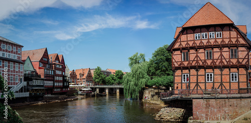 Half-timbered red bricks houses near the river at the old harbor of Luneburg, Germany photo