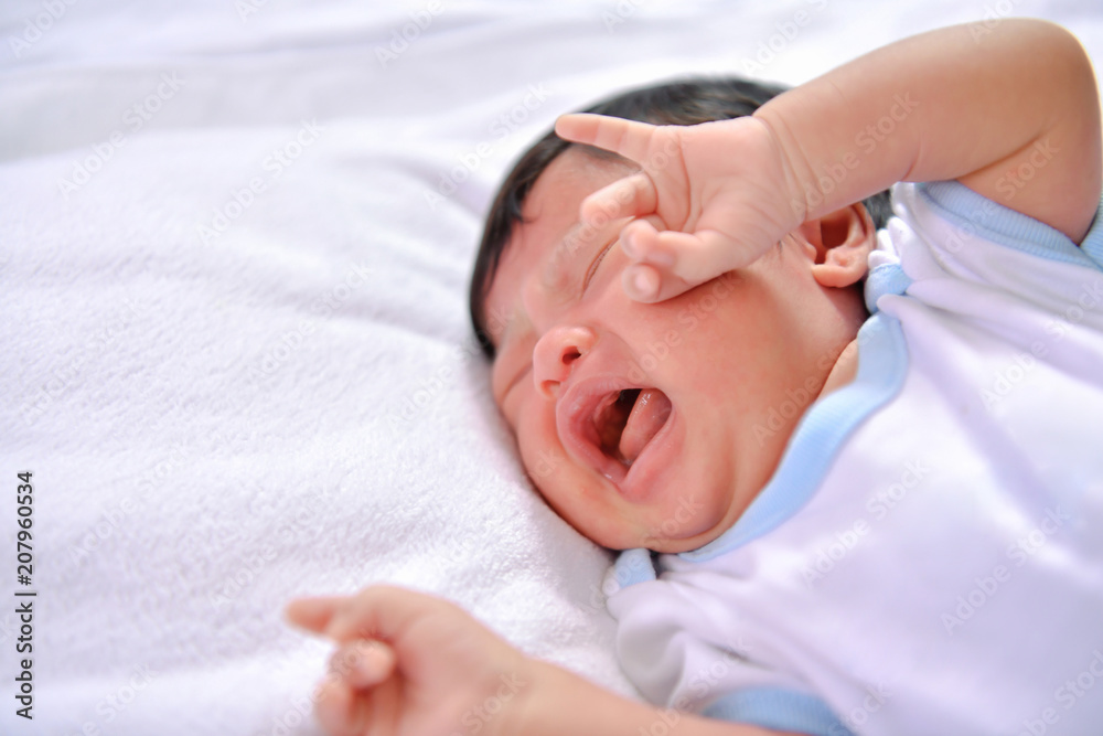 Newborn Concept. Newborn babies are sleeping in a bed. The baby is in the white bedroom. Newborn Concept. Newborn babies are sleeping in a bed. The baby is in the white bedroom.