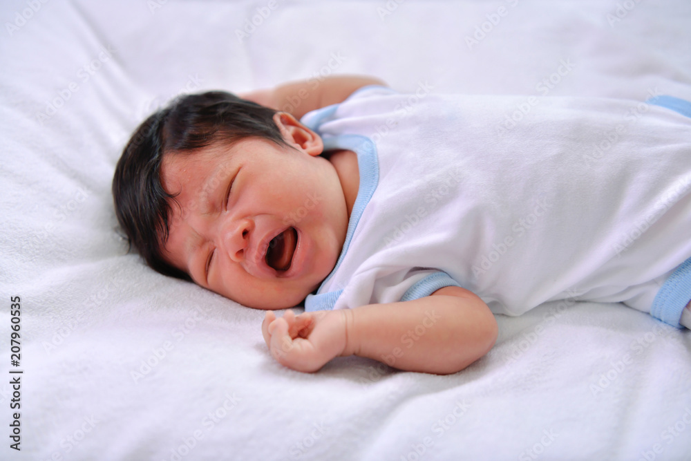 Newborn Concept. Newborn babies are sleeping in a bed. The baby is in the white bedroom. Newborn Concept. Newborn babies are sleeping in a bed. The baby is in the white bedroom.