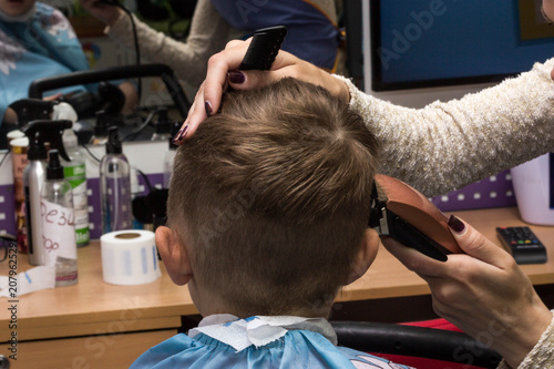 The child is sheared in a children's hairdresser's