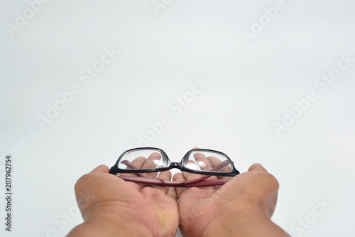 Two hand gestures giving black and red glasses isolated on white background