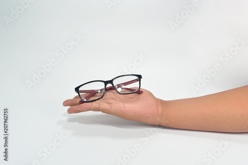 Hand showing black and red eyewear isolated on white background