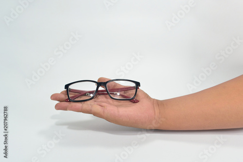 Hand showing black and red eyewear isolated on white background