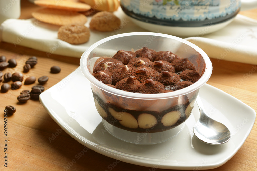 portion of tiramisu in the cup - traditional Italian dessert portion of tiramisu in the cup - traditional Italian dessert