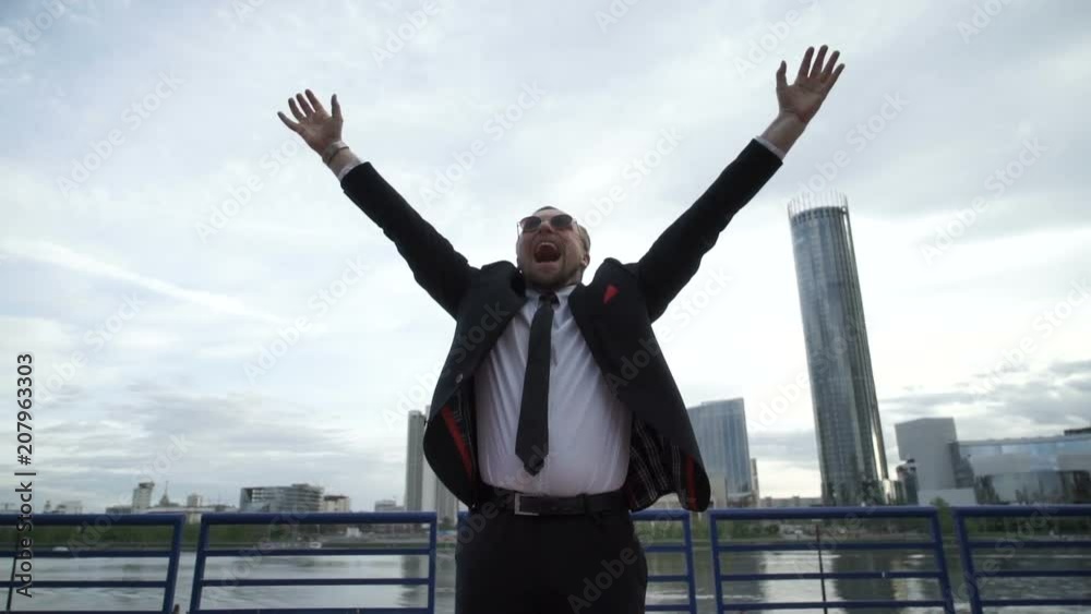 Businessman joyfully screaming in the street Businessman joyfully screaming in the street
