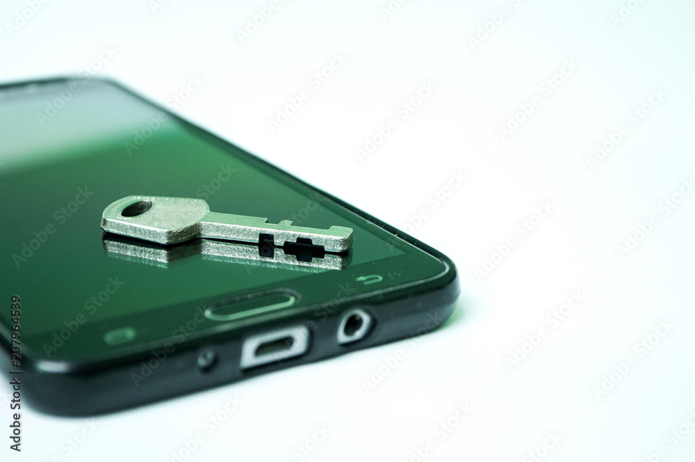 Fototapeta premium Black mobile phone with padlock and key isolated on white background