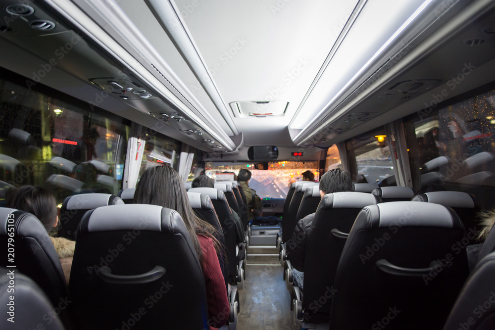 View from back seat in a bus. passengers in the public bus, Stock Photo
