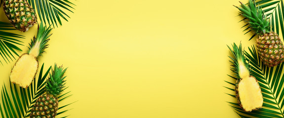 Pattern with bright pineapples on yellow background. Top View. Copy Space. Minimal style. Pop art design, creative summer concept. Banner