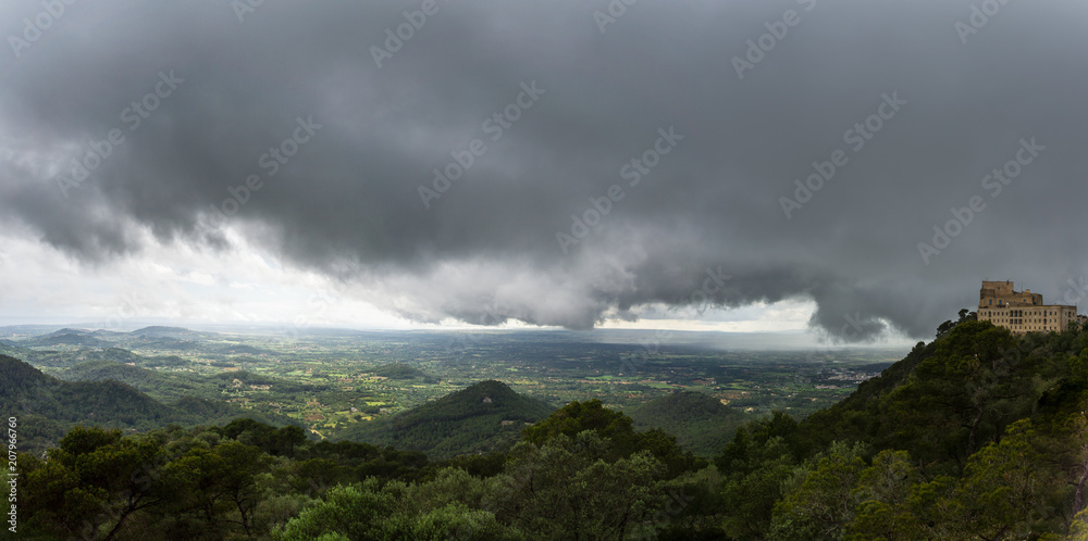 Mallorca, Panorama XXL nature landscape from Sant Salvador mountain with dark rain clouds