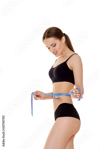 woman measuring waist with blue measuring tape. © producer