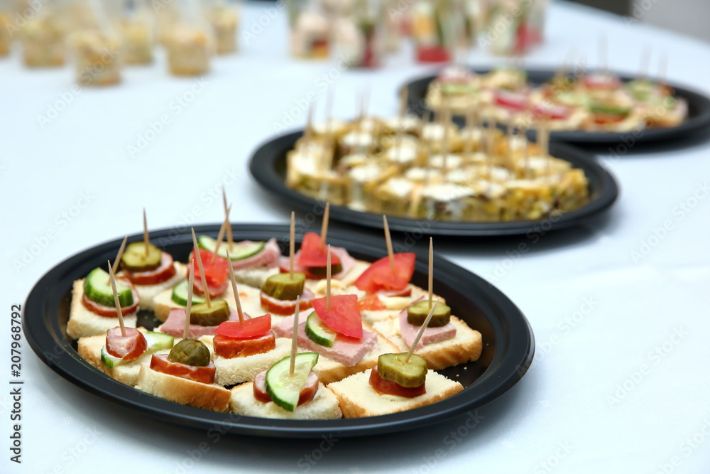 Popular and appetizing sandwiches for one bite pierced with a toothpick. Popular and appetizing sandwiches for one bite pierced with a toothpick.