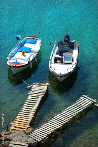 Fishing boats floating in turquoise water in Greece © pink candy
