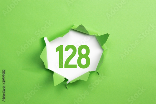 gruene Nummer 128 auf gruenem Papier