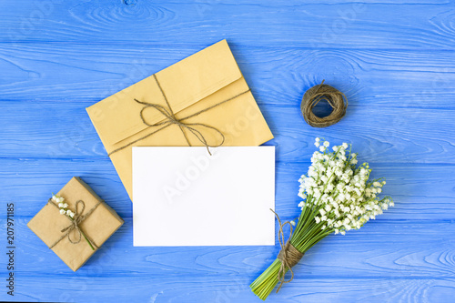 Mother's day. Women's day. Valentine's day, Birthday background. Lily of the Valley, envelope, packing gifts. Spring flat lay, top view photo