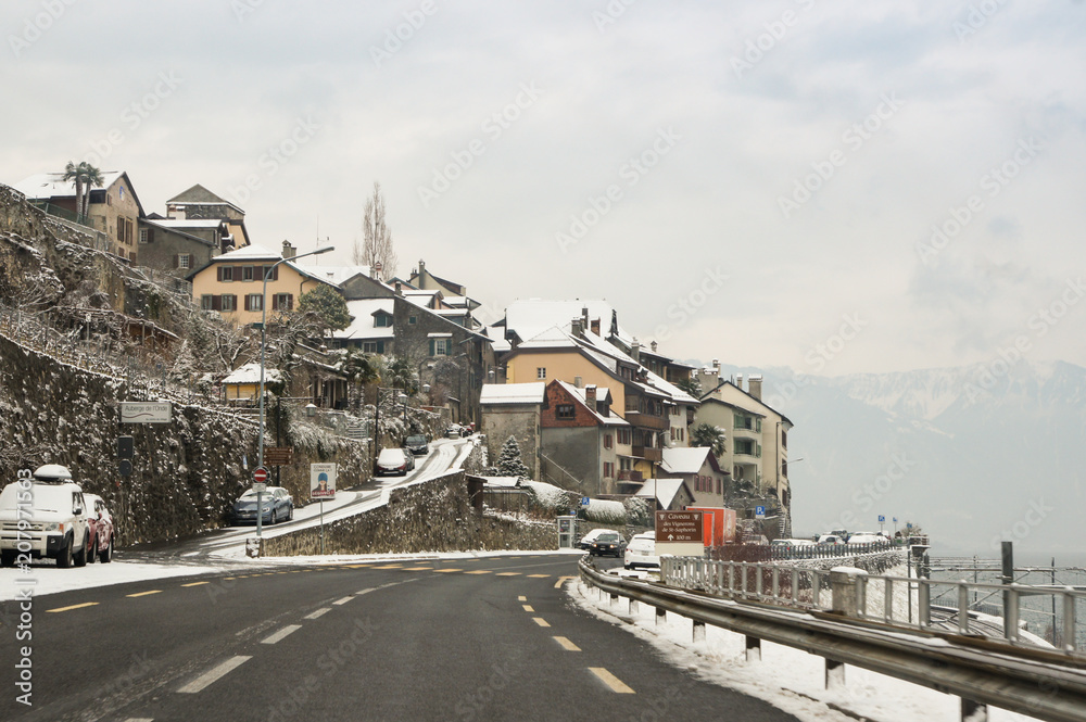 A village in the snow along the road.
