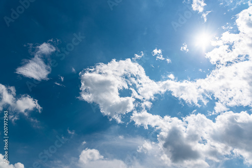 Blue sky with clouds and sun