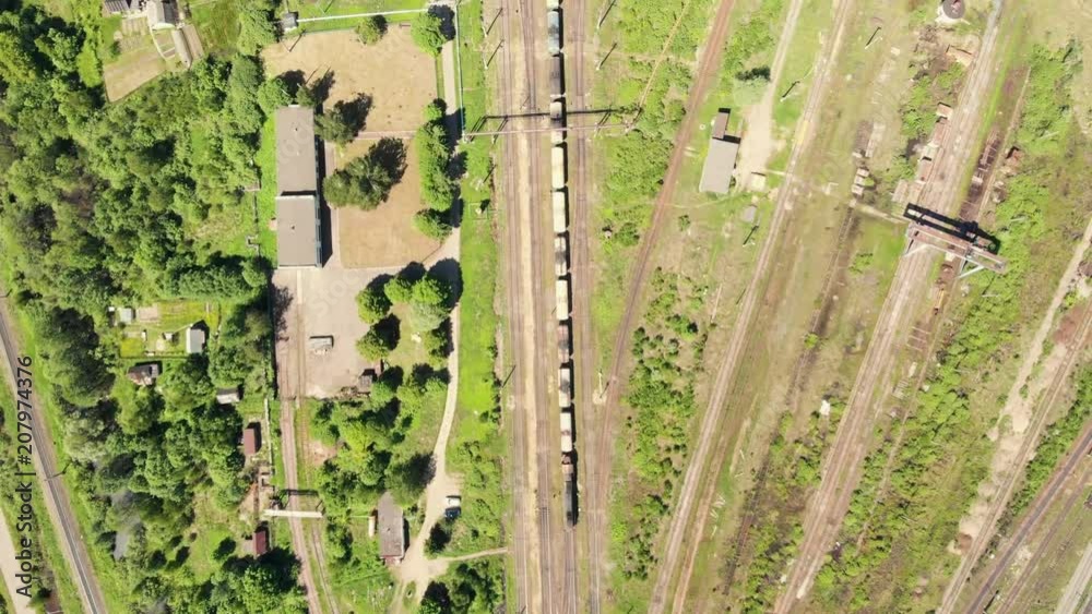 Branches of the railway at the marshalling yard, a lot of freight wagons from the height. Wagons with coal moving on rails Branches of the railway at the marshalling yard, a lot of freight wagons from the height. Wagons with coal moving on rails