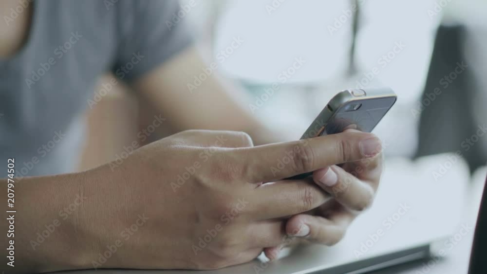 man using smartphone in cafe man using smartphone in cafe