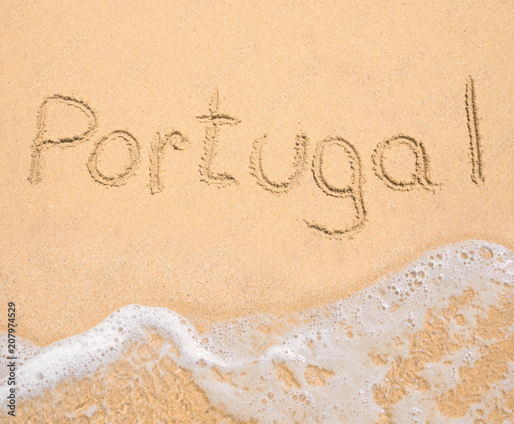 Fototapeta premium The word Portugal written in the sand on beach