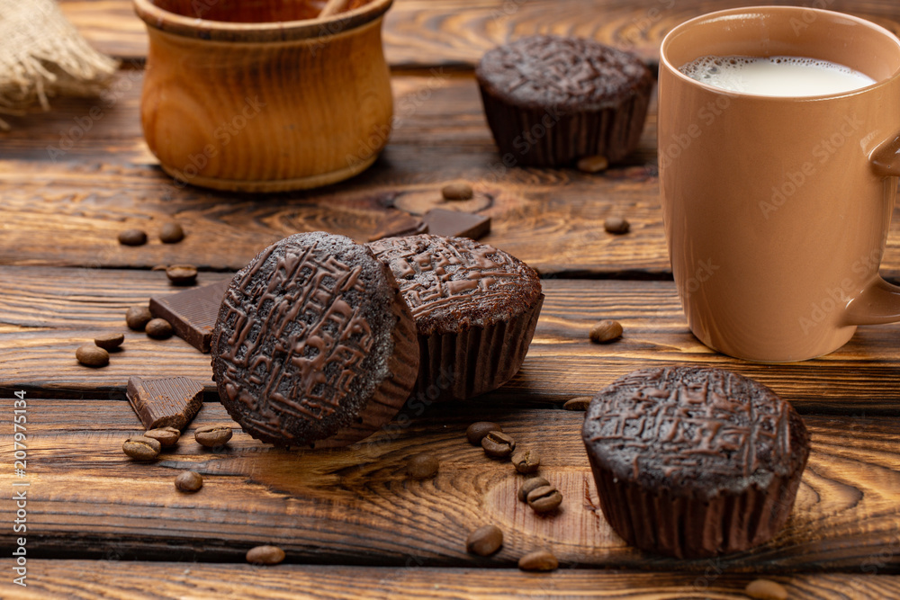 Chocolate muffins on a broun rustic wooden table - selective focus