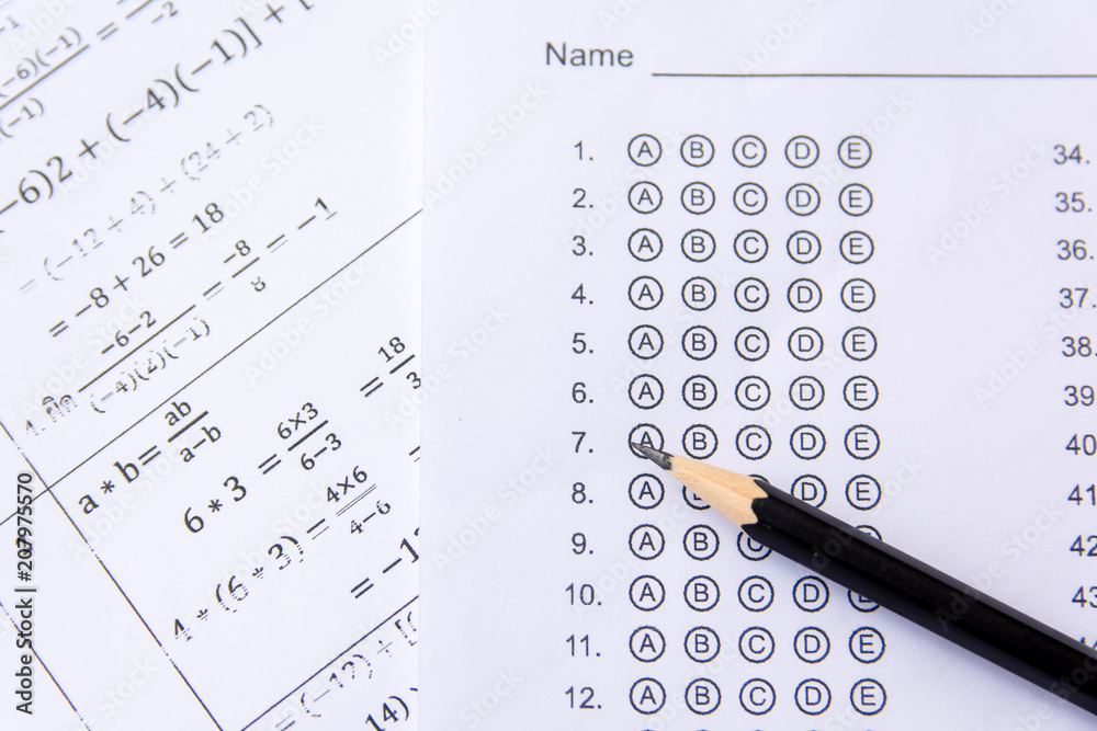 Pencil on answer sheets or Standardized test form with answers bubbled. multiple choice answer sheet Pencil on answer sheets or Standardized test form with answers bubbled. multiple choice answer sheet