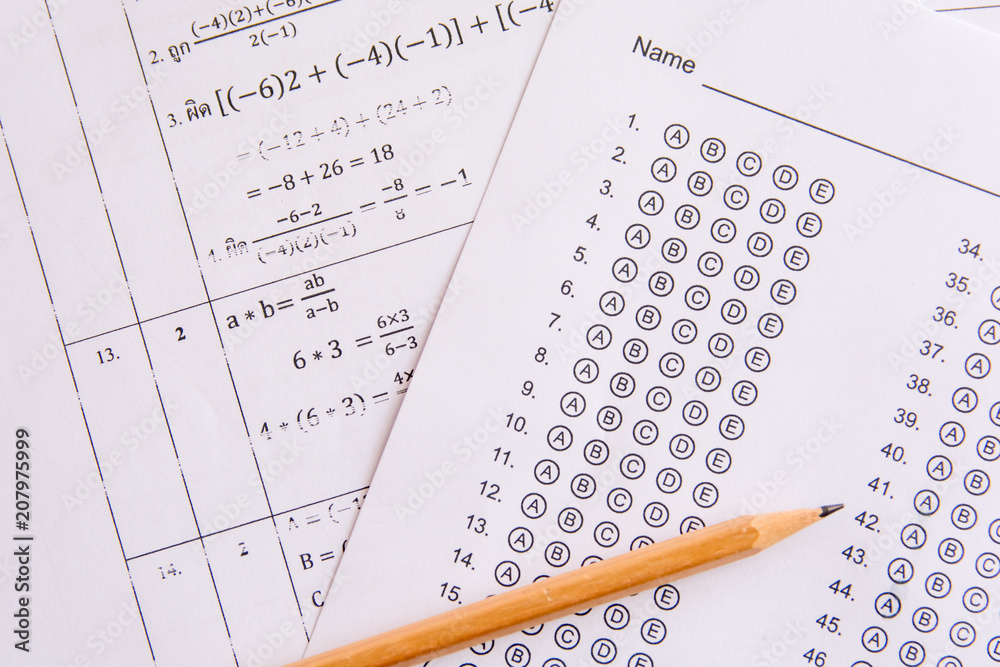 Pencil on answer sheets or Standardized test form with answers bubbled. multiple choice answer sheet Pencil on answer sheets or Standardized test form with answers bubbled. multiple choice answer sheet