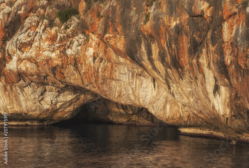 Rock with cave in ocean