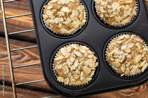 Homemade blueberry bran muffins with almond in bakeware photo