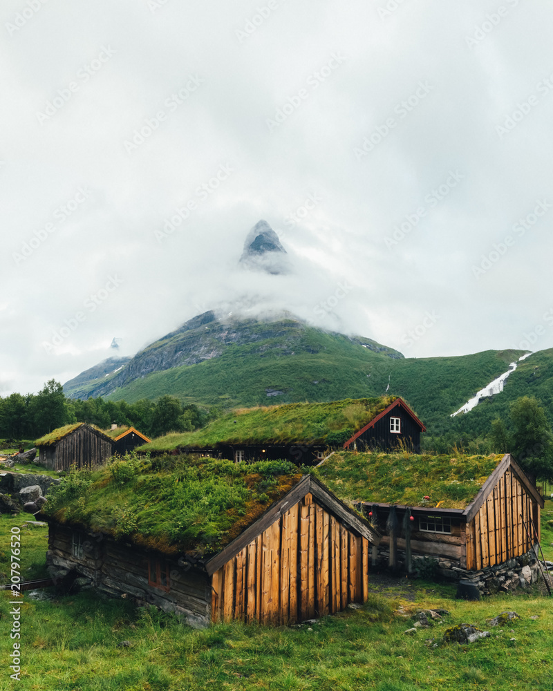 Obraz premium Typical norwegian old wooden houses with grass roofs in Innerdalen - Norway's most beautiful mountain valley, near Innerdalsvatna lake. Norway, Europe