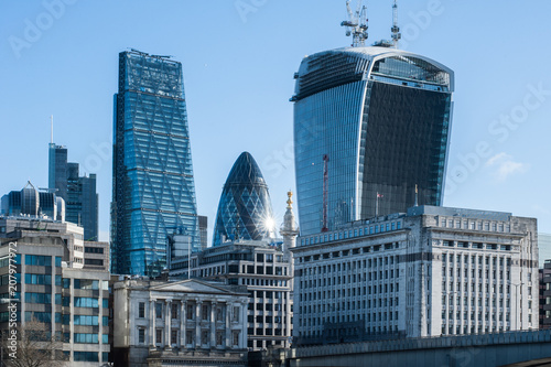 Skyscrapers of The City in London at sunrise in 2014. Buildings include 122 Leadenhall Street (aka the Cheesegrater), 30 St Mary Axe (aka The Gerkin) and 20 Fenchurch Street (aka The Walkie-Talkie)  photo