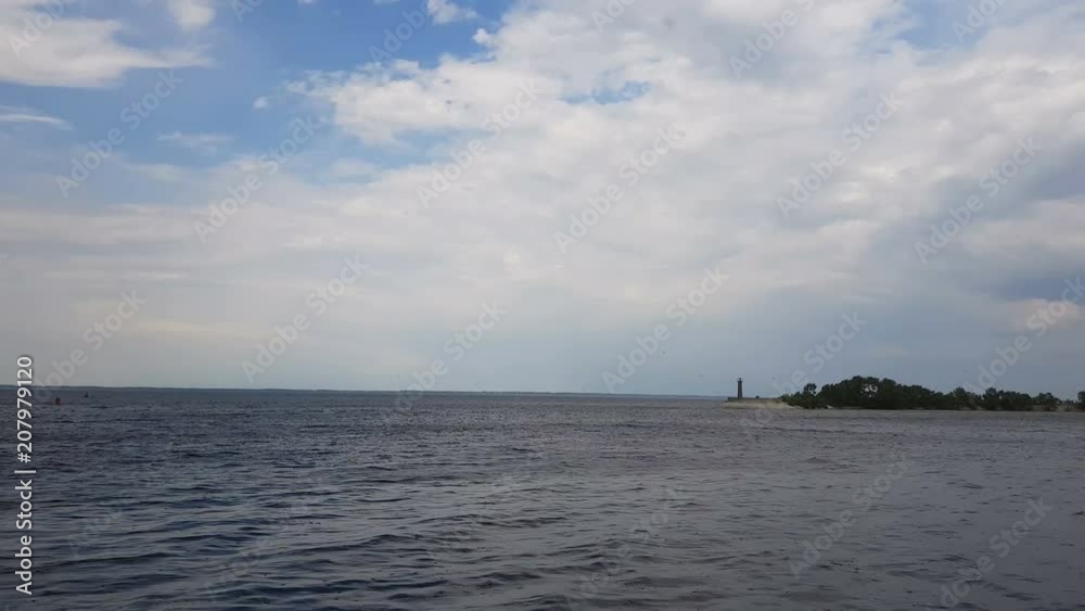 Cityscape and skyline in cloudy sky and river. Sunshine, blue sky. Mysterious clouds are flying very low over river. Cityscape and skyline in cloudy sky and river. Sunshine, blue sky. Mysterious clouds are flying very low over river.
