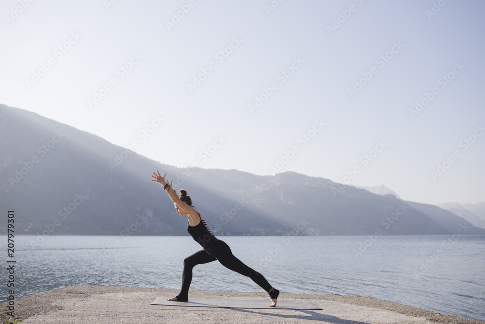 Woman doing variation of Warrior I Pose, Virabhadrasana I Woman doing variation of Warrior I Pose, Virabhadrasana I
