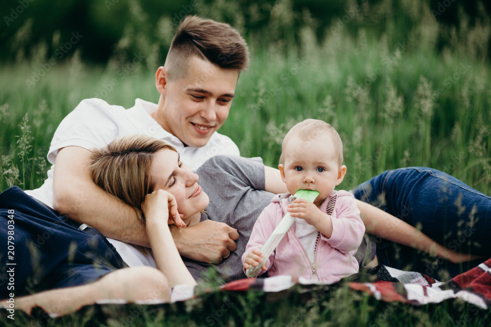 Couple with baby daughter enjoy time together Couple with baby daughter enjoy time together