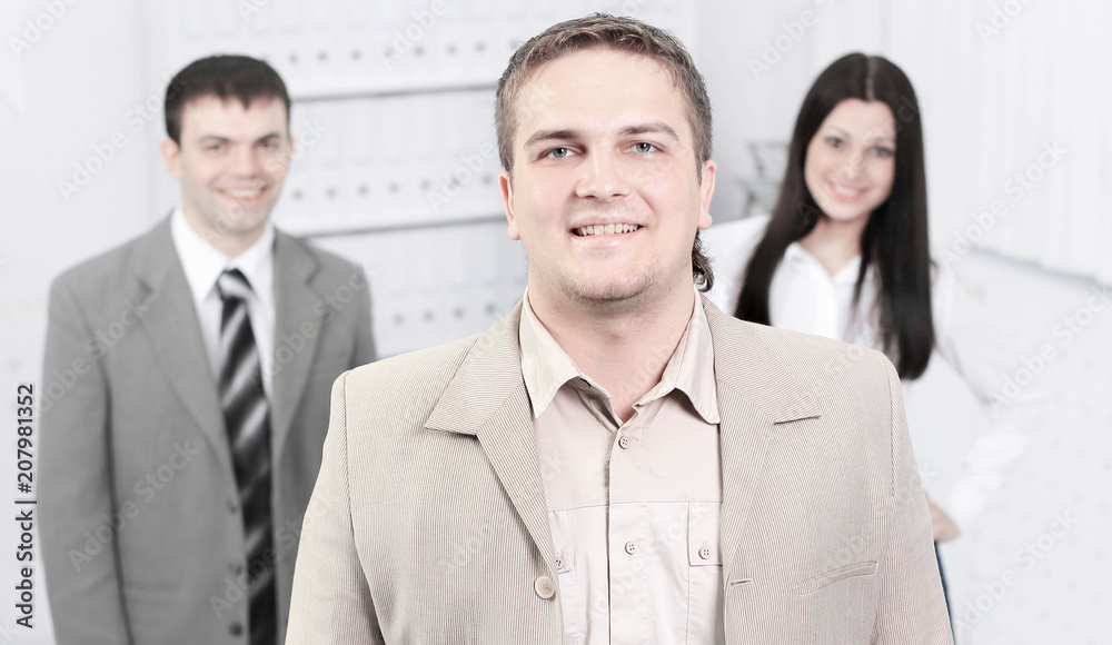 confident young businessman on background of office confident young businessman on background of office