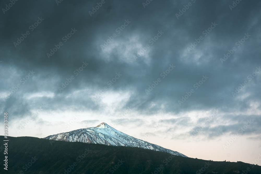Snow-covered volcano Teide and cloudy sky
