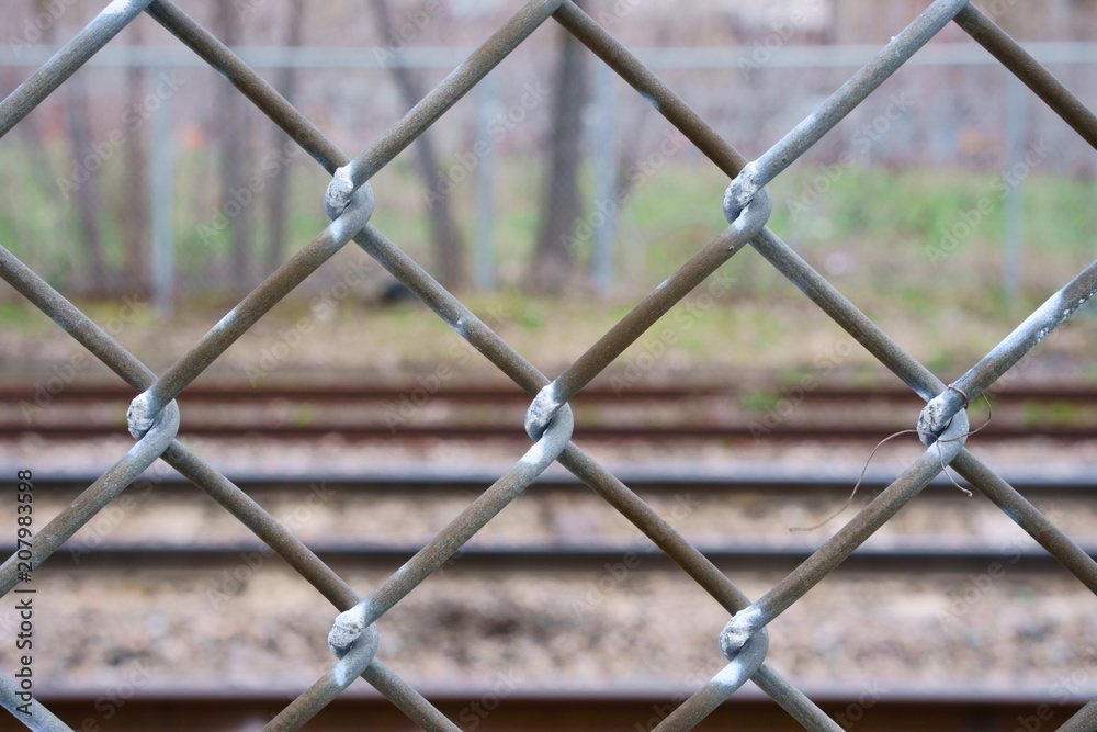 A fence along a railway track. A fence along a railway track.