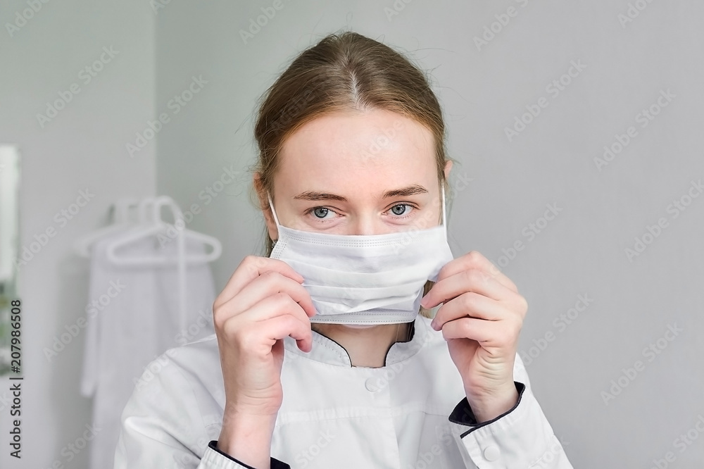 Cosmetologist in white medical mask on face. Cosmetologist in white medical mask on face.