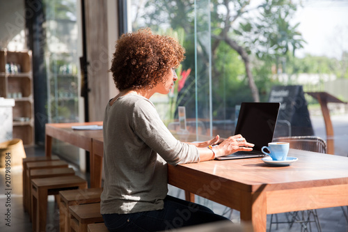 Wallpaper Mural Woman working on her laptop in a cafe Torontodigital.ca
