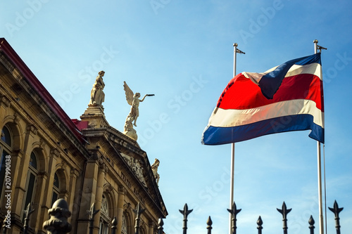 The flag of Costa Rica waving against the sun at the heart of San José