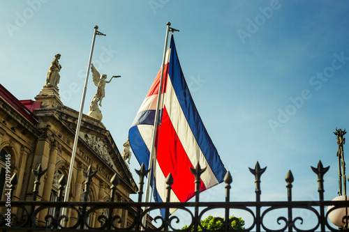 The flag of Costa Rica waving against the sun at the heart of San José