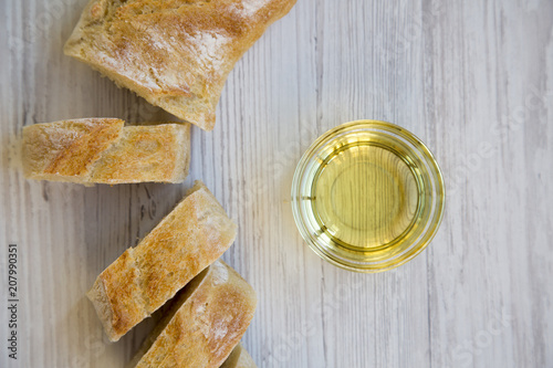 Chopped italian baguette with olive oil, clodeup. Top view. photo