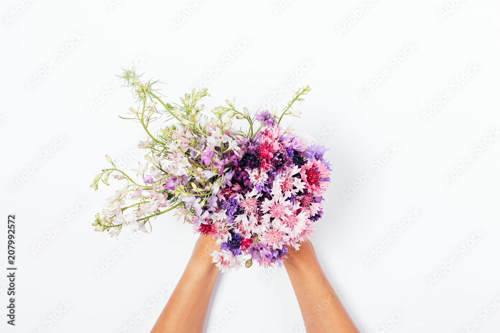 Female's hands holding summer bouquet Female's hands holding summer bouquet